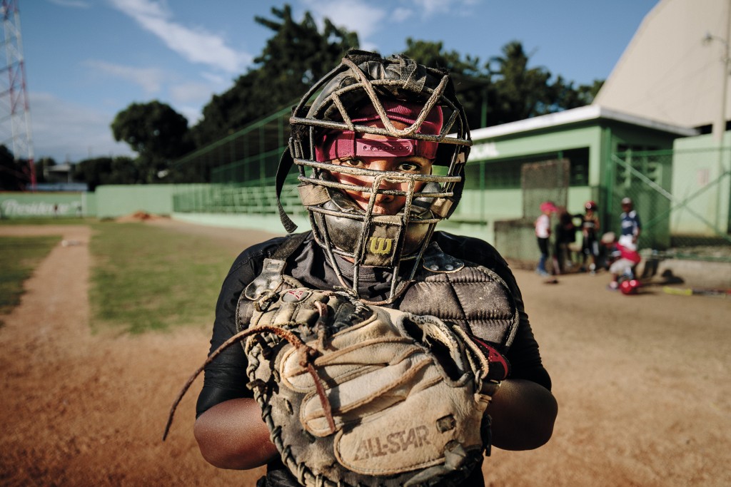 A very old catcher's mask from the Dominican Republic depicts the plight of the country's aspiring baseball players. Despite these socioeconomic challenges, more than 100 D.R. players were on major league opening day rosters, the first time a country outside the United States has cracked the century mark. (Courtesy of Jean Fruth.)
